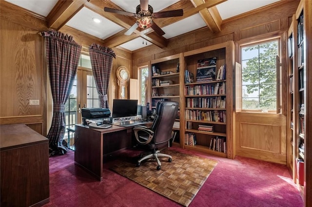 office space with wood walls, coffered ceiling, and beam ceiling