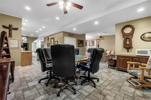 office space with crown molding, recessed lighting, decorative columns, and stone tile floors