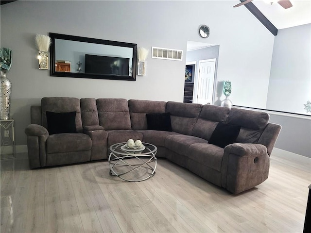 living room featuring high vaulted ceiling, wood finished floors, visible vents, baseboards, and a ceiling fan