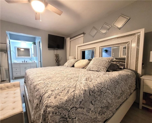 bedroom featuring ensuite bathroom, ceiling fan, and a sink