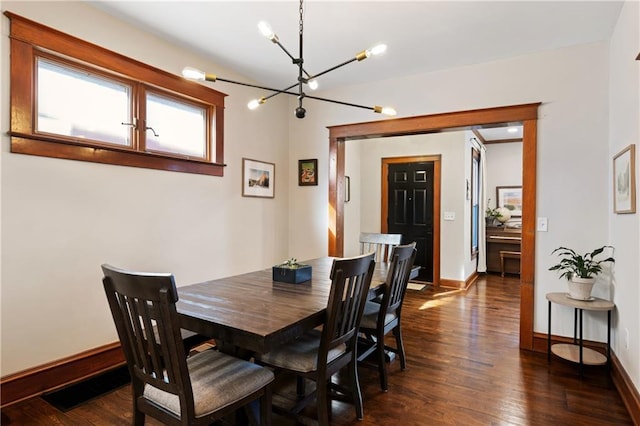 dining area with baseboards, an inviting chandelier, and dark wood-style floors