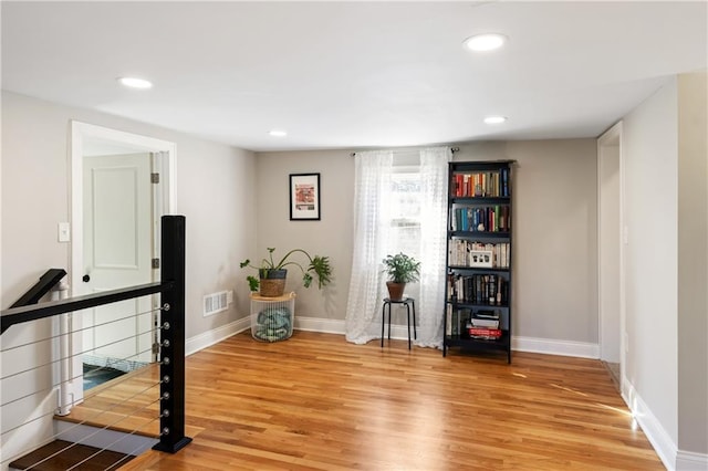 interior space featuring light wood-style flooring, recessed lighting, visible vents, and baseboards