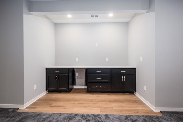 bar with baseboards, visible vents, built in study area, light wood-type flooring, and recessed lighting