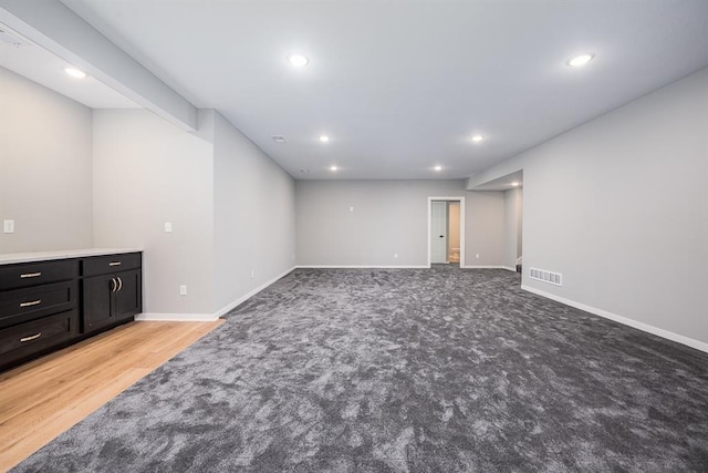 basement with recessed lighting, visible vents, and baseboards