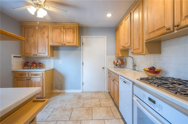 kitchen with light countertops, light tile patterned flooring, ceiling fan, a sink, and white appliances