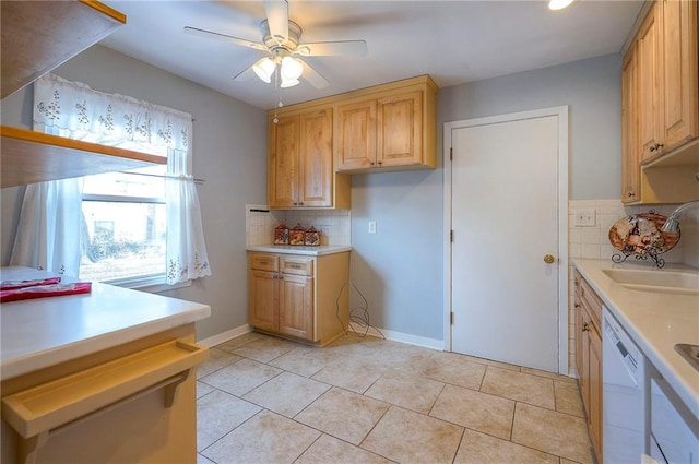 kitchen featuring dishwasher, ceiling fan, light countertops, a sink, and light tile patterned flooring