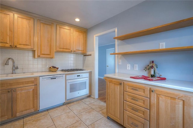 kitchen with white appliances, tasteful backsplash, light tile patterned floors, open shelves, and a sink