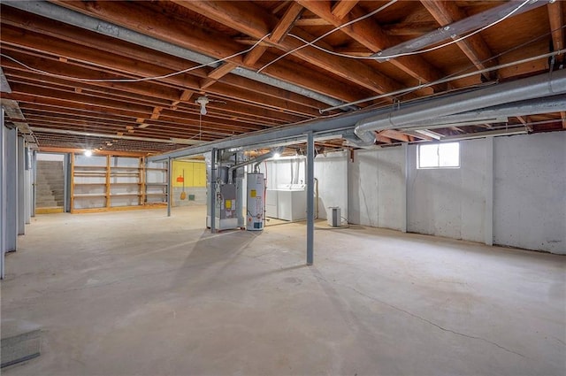 below grade area featuring gas water heater, washer and dryer, and heating unit