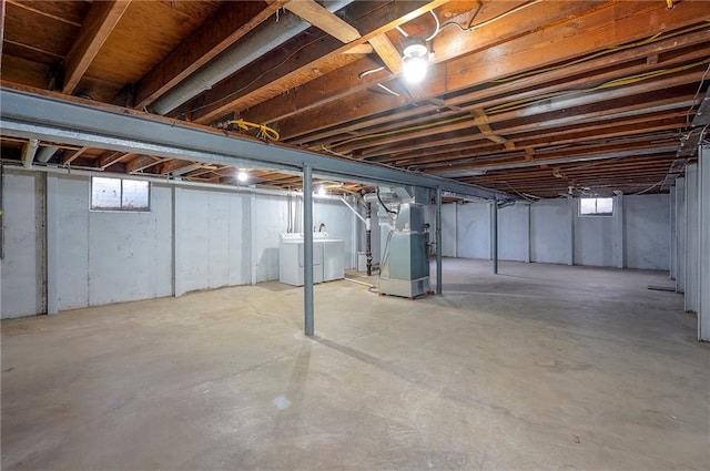 basement featuring heating unit and washer and dryer