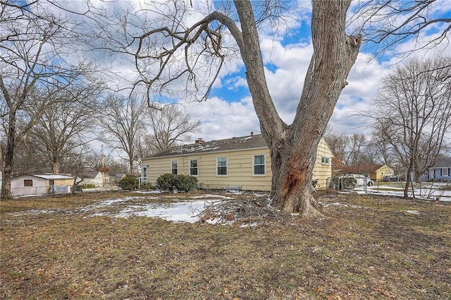 back of property with a chimney