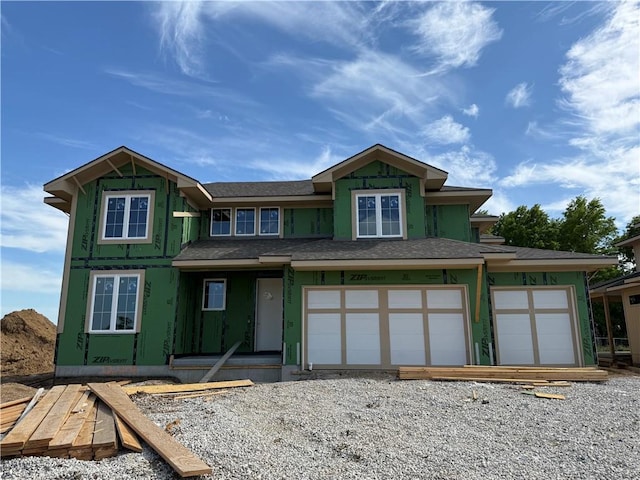 view of front of property with roof with shingles, a garage, and driveway
