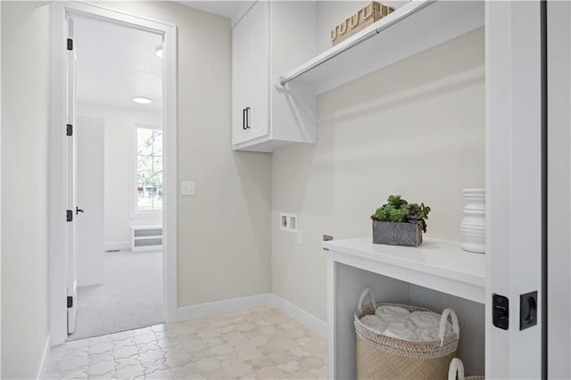 laundry room featuring cabinet space, hookup for a washing machine, baseboards, and electric dryer hookup