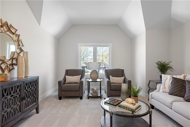 living room featuring light carpet, baseboards, and lofted ceiling