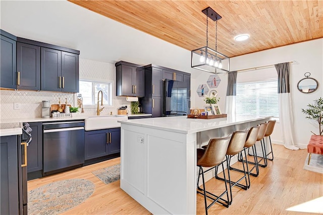 kitchen with wooden ceiling, a breakfast bar, a kitchen island, a sink, and dishwasher