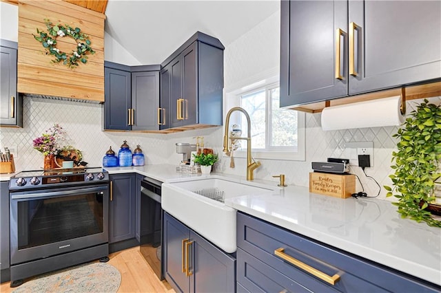 kitchen featuring stainless steel range with electric stovetop, light countertops, and a sink