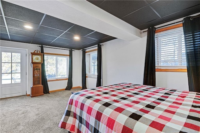 bedroom featuring carpet floors, a paneled ceiling, and baseboards