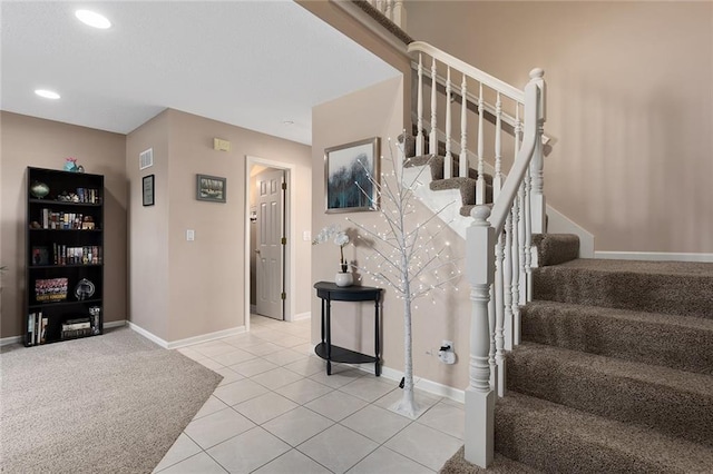 stairs with recessed lighting, visible vents, tile patterned flooring, and baseboards