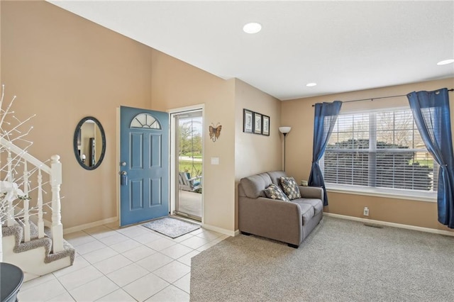 foyer featuring stairs, light tile patterned flooring, baseboards, visible vents, and recessed lighting