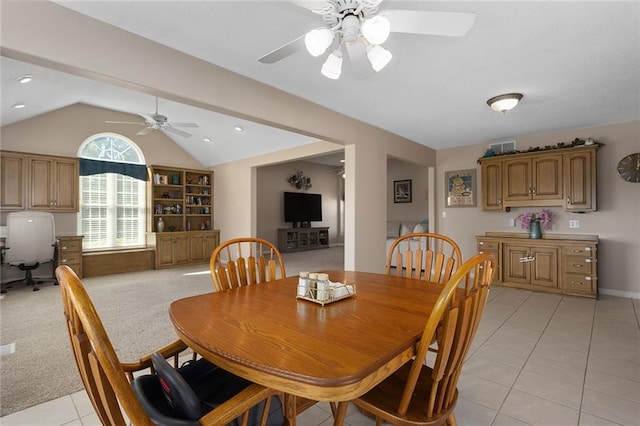 dining space with lofted ceiling, a ceiling fan, and light tile patterned floors