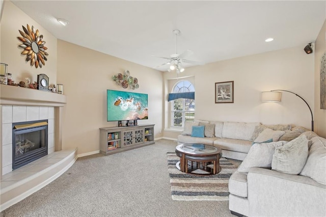 carpeted living area featuring a fireplace, baseboards, ceiling fan, and recessed lighting