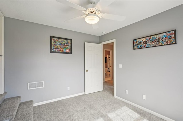 unfurnished bedroom with carpet, visible vents, a ceiling fan, and baseboards