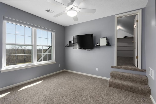 unfurnished living room with ceiling fan, baseboards, carpet flooring, and visible vents
