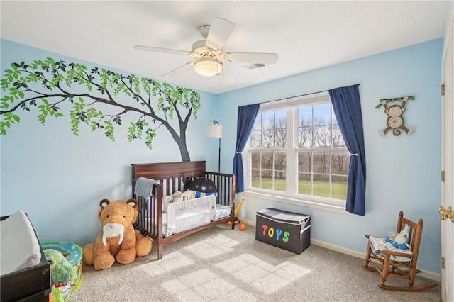 11319 Easley Dr, Lees Summit, MO 64086 - carpeted bedroom with a crib, baseboards, and a ceiling fan