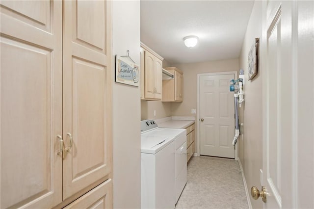 clothes washing area with cabinet space, baseboards, and separate washer and dryer