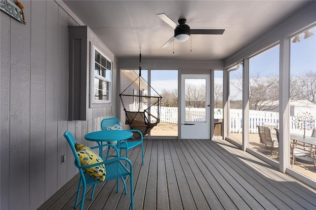 sunroom / solarium with a wealth of natural light and ceiling fan