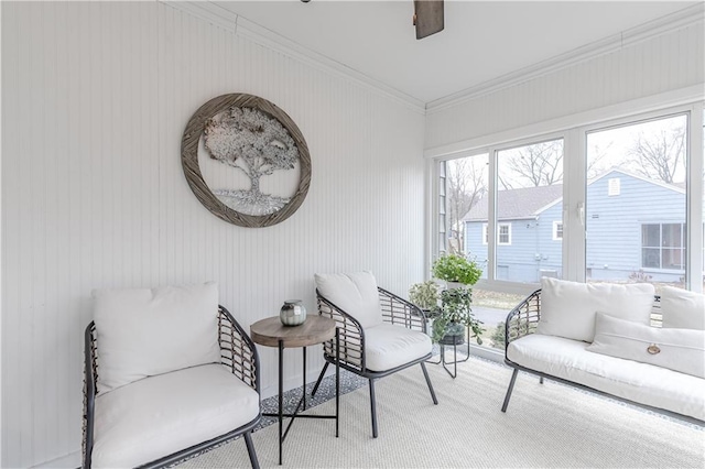 sitting room with carpet floors and ornamental molding