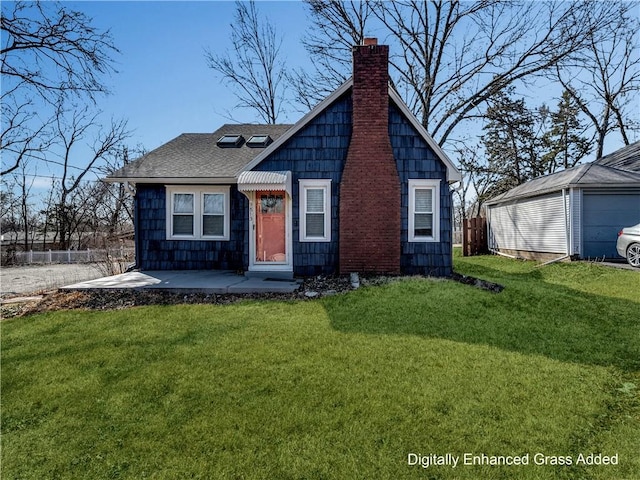 view of front of home with roof with shingles, a chimney, a front lawn, and fence