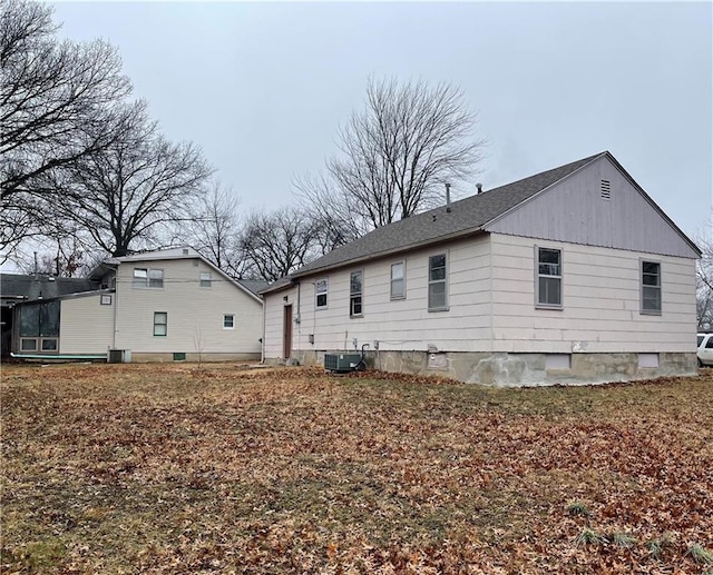 back of property with cooling unit and crawl space