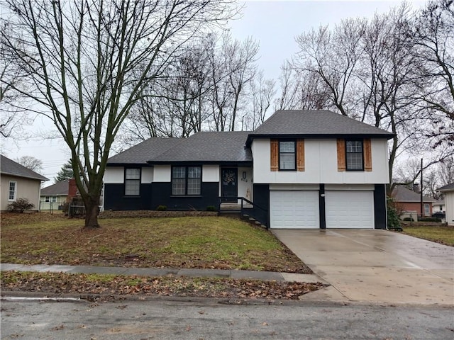 tri-level home with driveway, a front lawn, an attached garage, and stucco siding