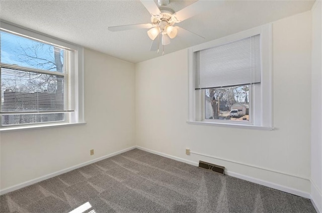 314 N 6th St, Leavenworth, KS 66048 - empty room with visible vents, a ceiling fan, carpet flooring, a textured ceiling, and baseboards