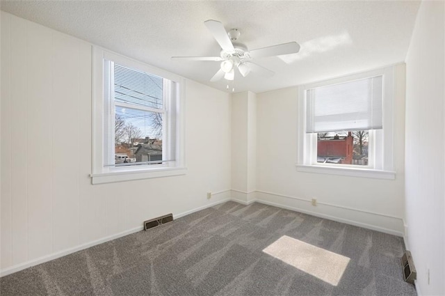 314 N 6th St, Leavenworth, KS 66048 - empty room featuring carpet floors, plenty of natural light, visible vents, and baseboards