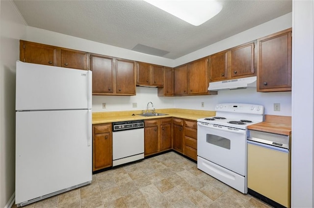 314 N 6th St, Leavenworth, KS 66048 - kitchen featuring a textured ceiling, under cabinet range hood, white appliances, a sink, and light countertops