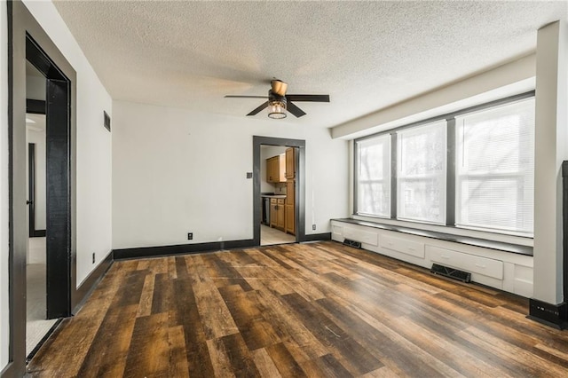 unfurnished room with visible vents, baseboards, ceiling fan, and wood finished floors