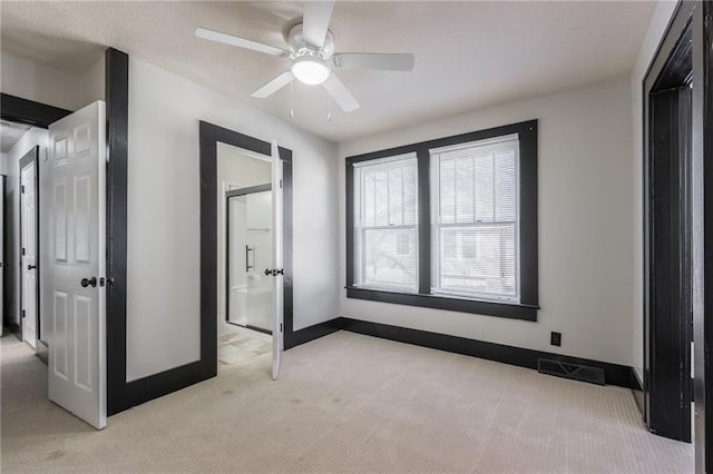 unfurnished bedroom with visible vents, light carpet, baseboards, and ceiling fan