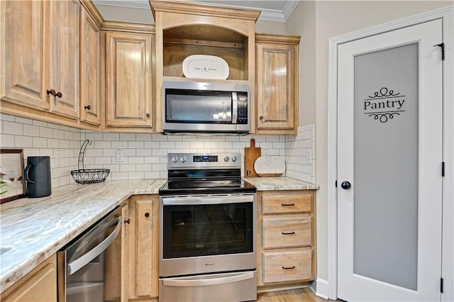 kitchen with light brown cabinets, crown molding, light stone counters, decorative backsplash, and stainless steel appliances