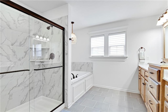 bathroom with a marble finish shower, baseboards, a bath, and vanity