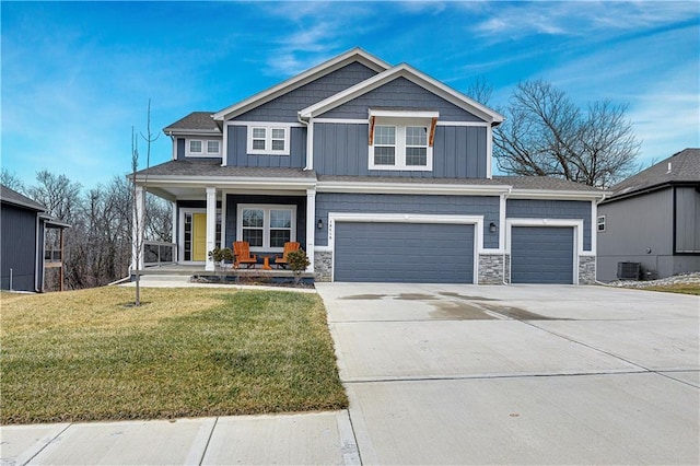 craftsman inspired home with board and batten siding, a porch, concrete driveway, a front yard, and stone siding