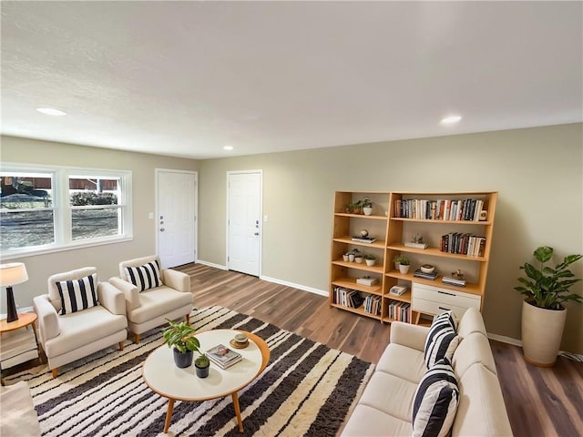 living room featuring recessed lighting, wood finished floors, and baseboards