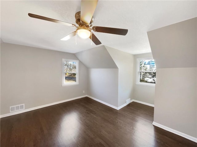 bonus room with baseboards, visible vents, lofted ceiling, ceiling fan, and wood finished floors