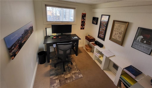 carpeted home office with baseboards