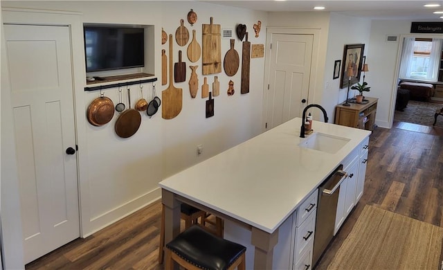 kitchen with dark wood finished floors, light countertops, and a sink