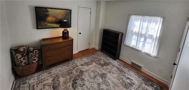 interior space featuring wood finished floors, visible vents, and baseboards