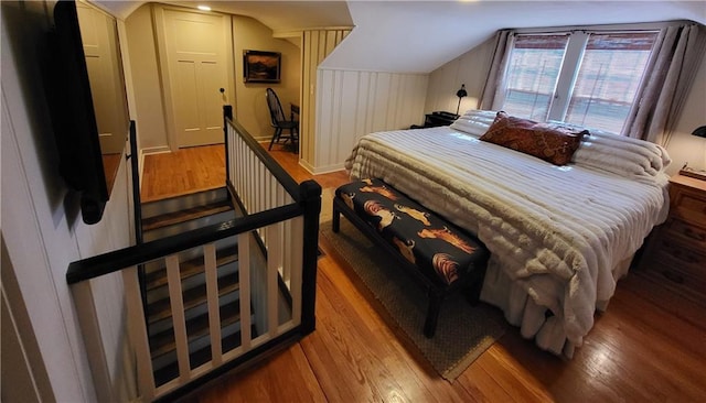 bedroom featuring lofted ceiling and wood finished floors