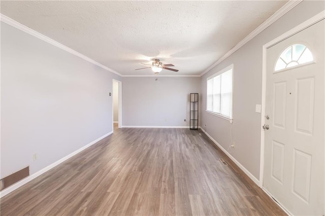 foyer entrance featuring ceiling fan, a textured ceiling, baseboards, and wood finished floors