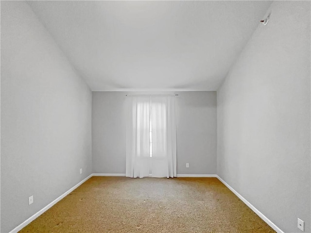 carpeted spare room with baseboards