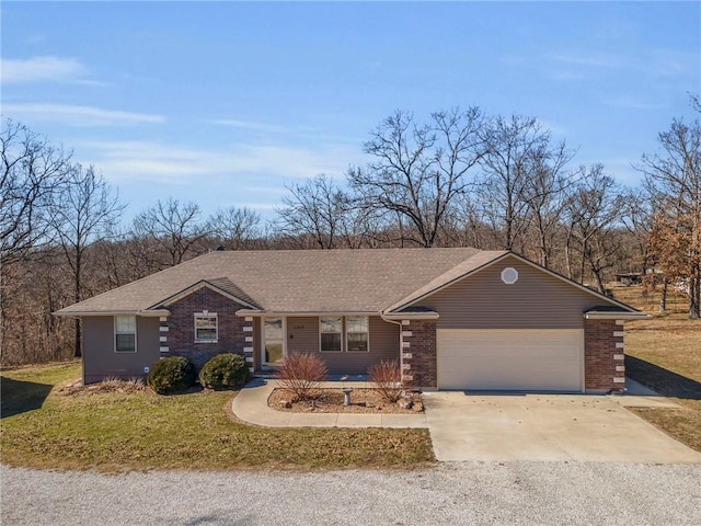 view of front of house featuring a garage, concrete driveway, brick siding, and a front yard